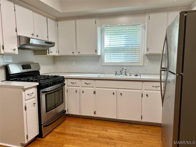 kitchen featuring white cabinetry, sink, appliances with stainless steel finishes, and light hardwood / wood-style flooring