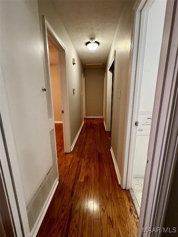 corridor featuring dark hardwood / wood-style flooring