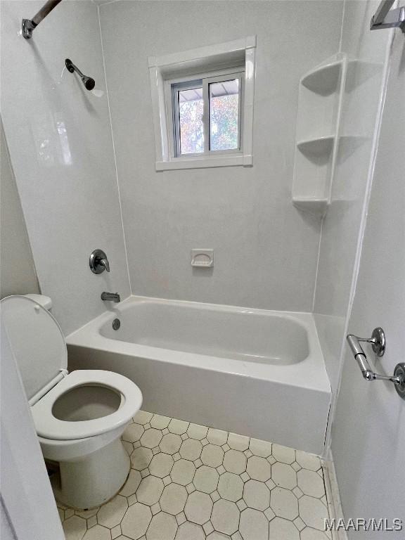 bathroom featuring  shower combination and toilet