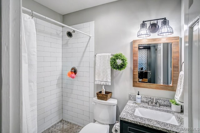 bathroom featuring a shower with shower curtain, vanity, and toilet