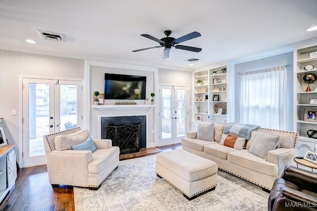 living room featuring french doors, ceiling fan, a healthy amount of sunlight, and hardwood / wood-style floors