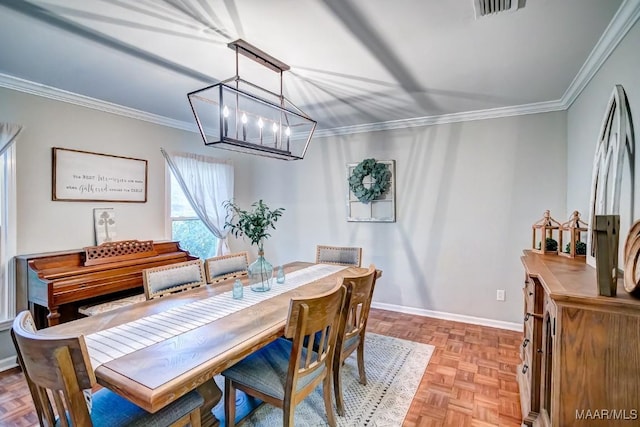 dining space with light parquet floors, a notable chandelier, and ornamental molding