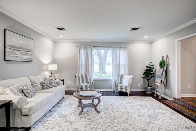 living room with crown molding and hardwood / wood-style floors