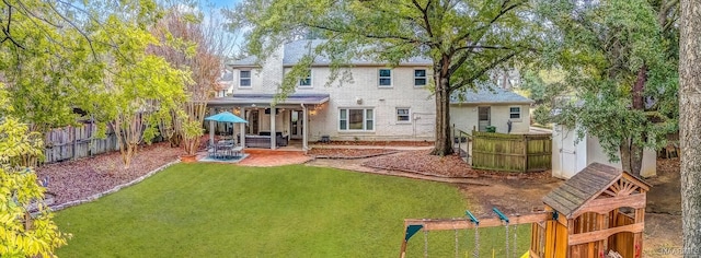 rear view of house featuring a patio and a lawn