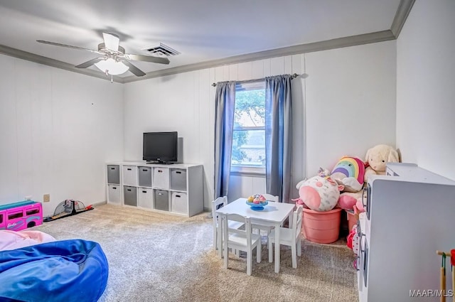 rec room with ceiling fan, ornamental molding, and carpet floors