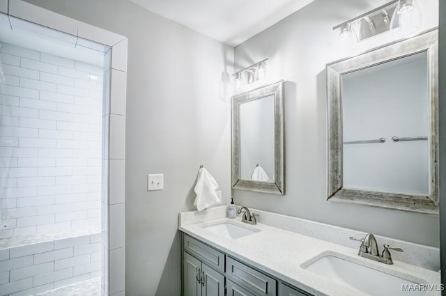 bathroom with vanity and tiled shower