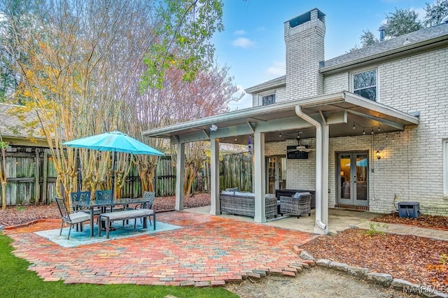 rear view of property featuring french doors, an outdoor hangout area, ceiling fan, and a patio area