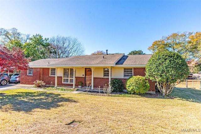 ranch-style home with a front yard and a porch