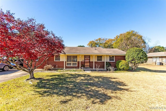 ranch-style house with cooling unit, a porch, and a front lawn