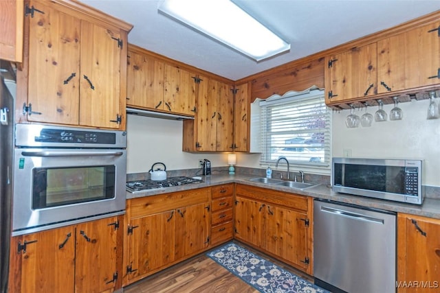 kitchen with hardwood / wood-style floors, sink, and stainless steel appliances