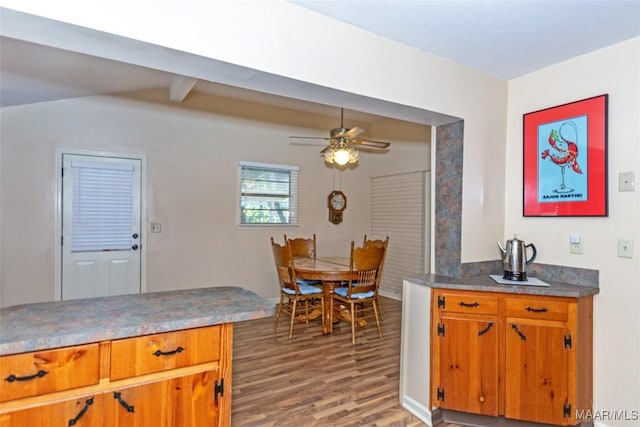 kitchen featuring hardwood / wood-style floors, ceiling fan, and beam ceiling