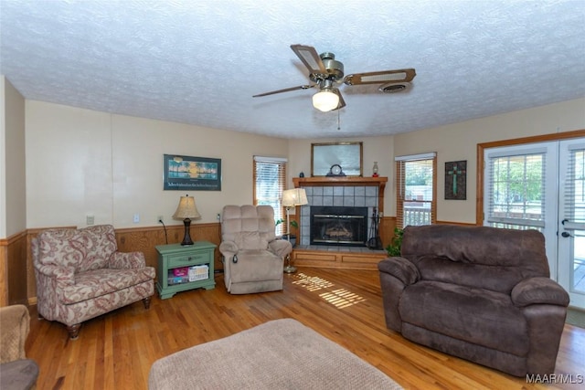 living room with ceiling fan, hardwood / wood-style floors, and a healthy amount of sunlight