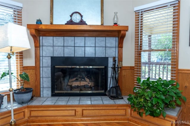 interior details featuring a tile fireplace