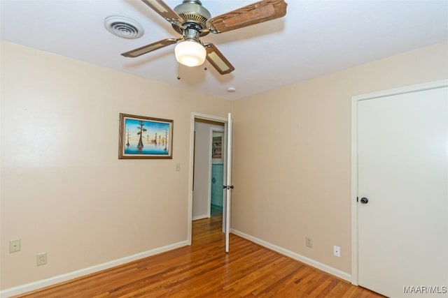 unfurnished room featuring ceiling fan and hardwood / wood-style floors