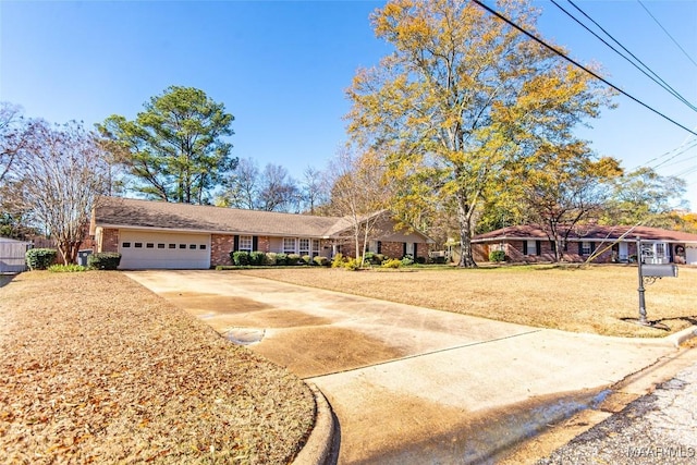 single story home featuring a garage and a front yard