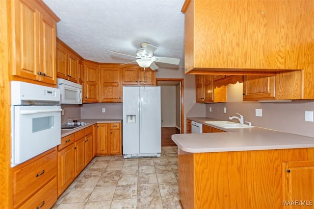 kitchen with ceiling fan, sink, kitchen peninsula, a textured ceiling, and white appliances