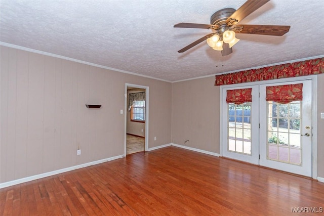 unfurnished room featuring hardwood / wood-style floors, ceiling fan, crown molding, and a textured ceiling