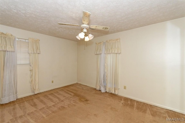 unfurnished room featuring a textured ceiling, carpet floors, and ceiling fan