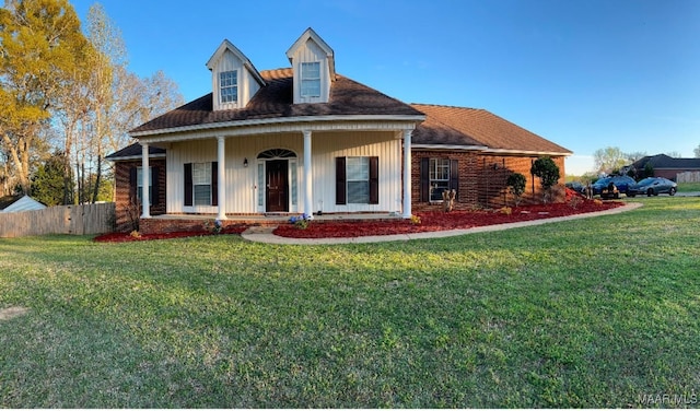 view of front of property with covered porch and a front yard