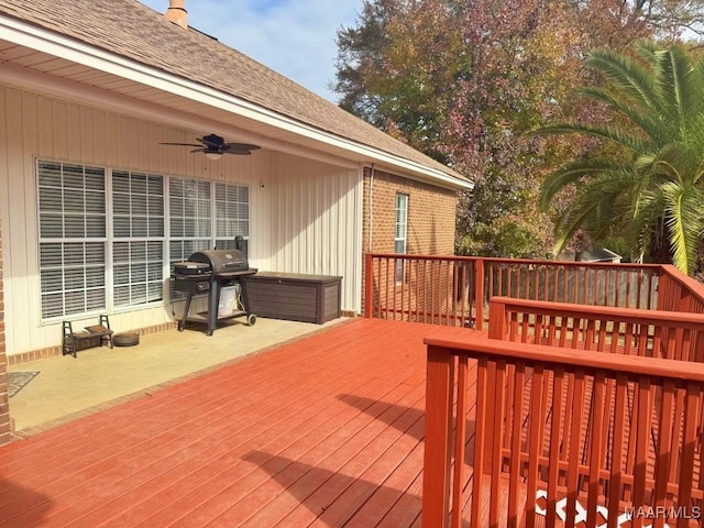 wooden deck with ceiling fan and area for grilling