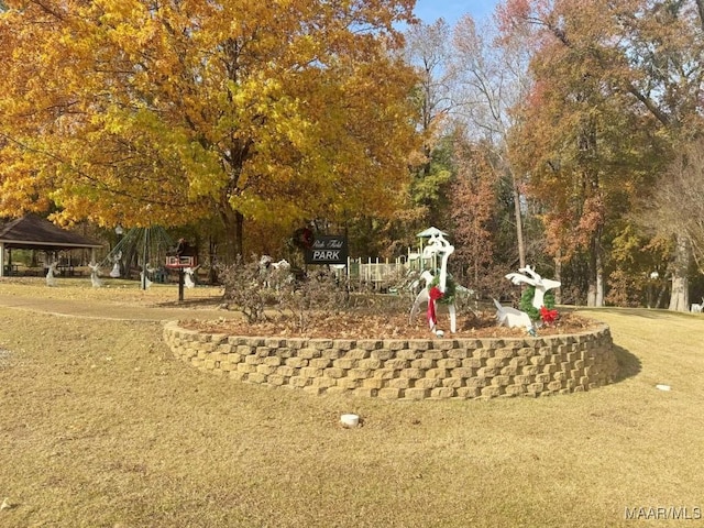 surrounding community featuring a gazebo and a lawn