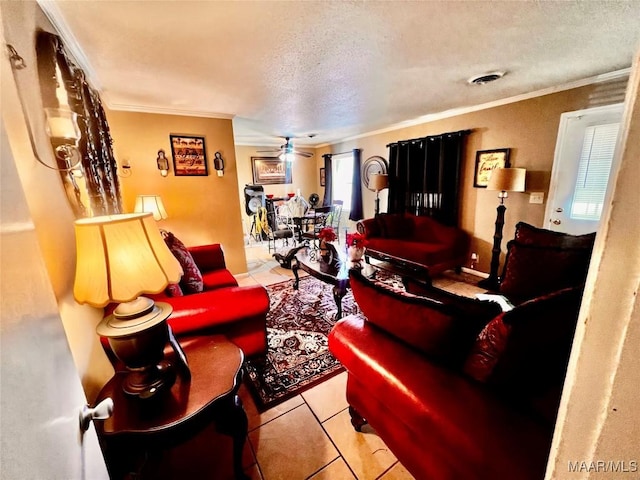 living room with ceiling fan, light tile patterned flooring, a textured ceiling, and ornamental molding