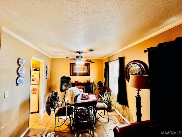 dining space with light tile patterned floors, a textured ceiling, ceiling fan, and crown molding