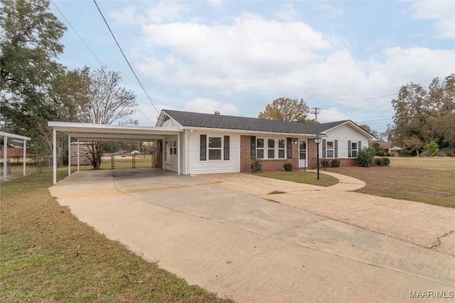 ranch-style home featuring a carport and a front lawn