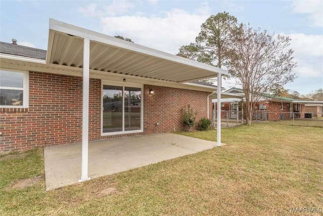 rear view of property featuring a yard and a patio