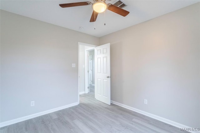 spare room with light hardwood / wood-style flooring and ceiling fan