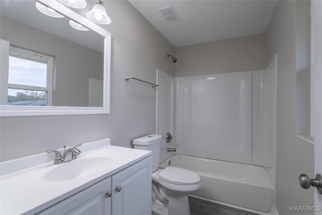 full bathroom featuring shower / bath combination, a textured ceiling, toilet, vanity, and hardwood / wood-style flooring