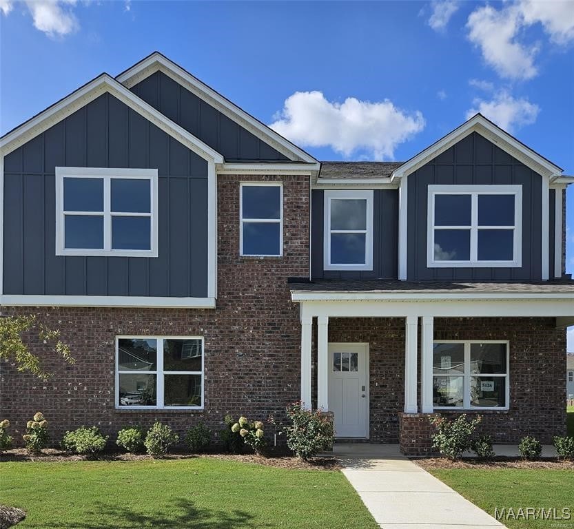 view of front of house featuring a porch and a front lawn