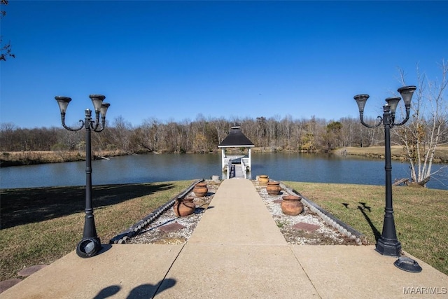 view of dock featuring a yard and a water view