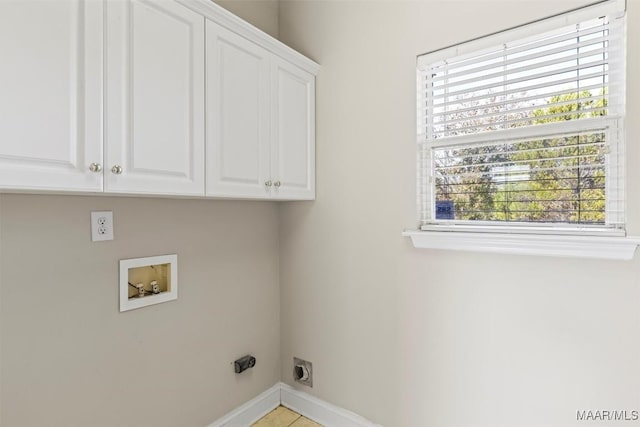 clothes washing area with electric dryer hookup, hookup for a washing machine, cabinets, and a wealth of natural light