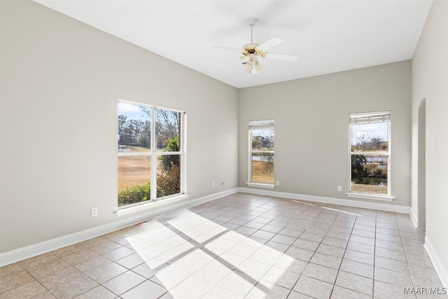 unfurnished room featuring ceiling fan and light tile patterned flooring