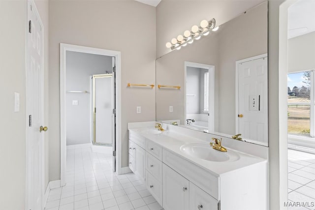 bathroom featuring tile patterned flooring, vanity, and shower with separate bathtub