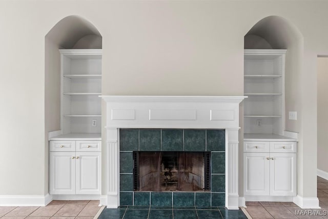 room details with built in features and a tiled fireplace