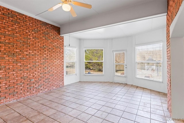 unfurnished sunroom with ceiling fan