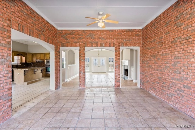 interior space with ceiling fan and exterior kitchen