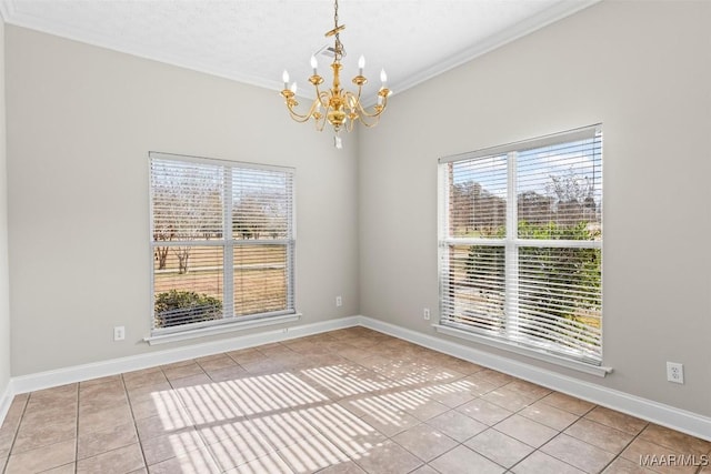 tiled spare room featuring a healthy amount of sunlight, ornamental molding, a textured ceiling, and an inviting chandelier