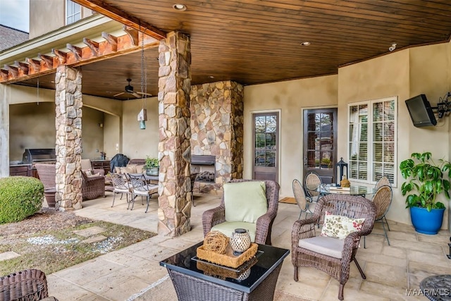 view of patio / terrace featuring ceiling fan and exterior kitchen