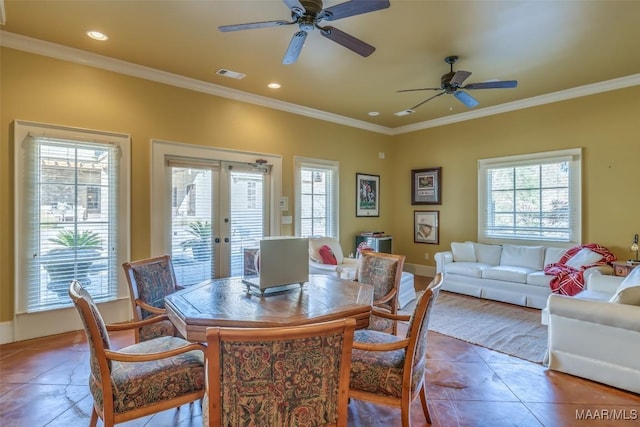 tiled dining room featuring a wealth of natural light, french doors, ceiling fan, and ornamental molding