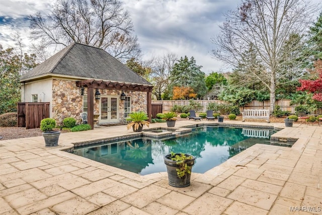 view of swimming pool with an in ground hot tub, french doors, and a patio