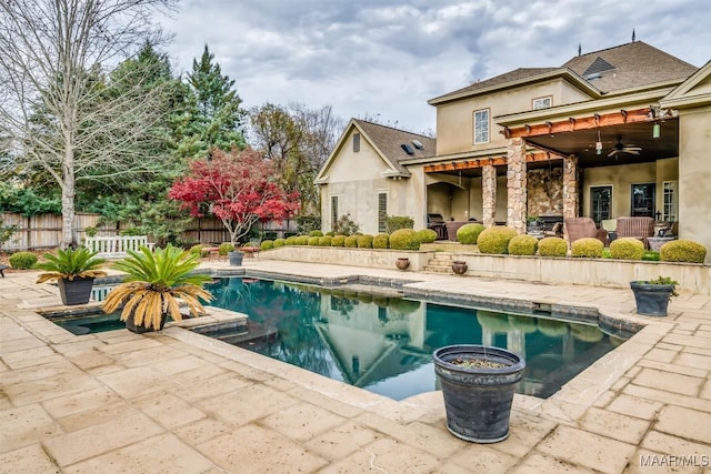 view of swimming pool featuring ceiling fan and a patio