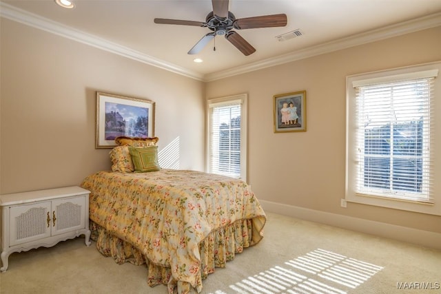 carpeted bedroom with ceiling fan and crown molding