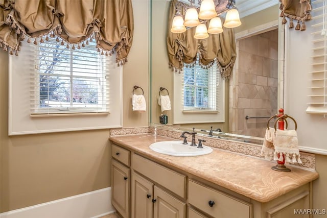 bathroom with vanity, plenty of natural light, and ornamental molding