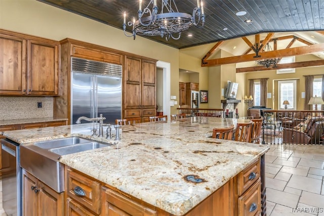 kitchen with stainless steel appliances, light stone counters, and wooden ceiling