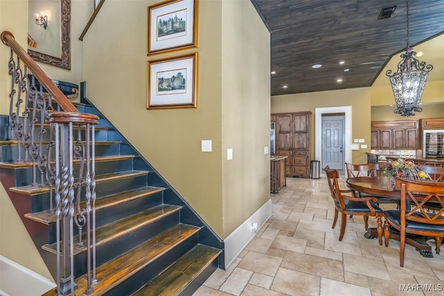 stairs with an inviting chandelier