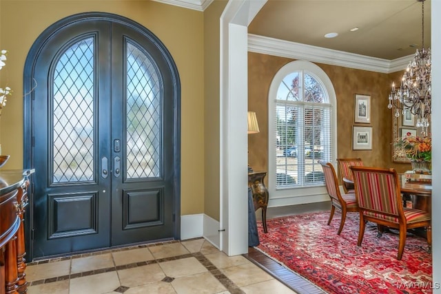 foyer featuring light tile patterned flooring, crown molding, and a chandelier