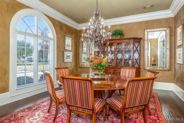 dining room featuring dark hardwood / wood-style flooring, ornamental molding, and an inviting chandelier